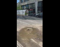 Muddy water overflow from hole on street