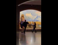 Dad filming kids fighting with lightsabers