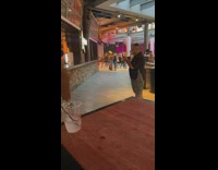 Man takes picture of woman that leans on the counter