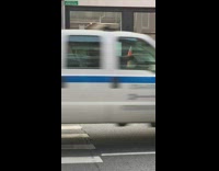 Guy orange traffic cone over head sidewalk 