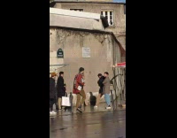 Lady poses under commemorative plaque paris attacks 