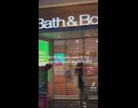 Group of people in empty mall waiting outside of bath and bodyworks 