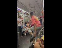 Guy dances on pole in subway to music