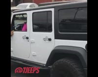 Woman backs up Jeep into wall