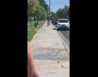 Two girls tiktok dance sidewalk white SUV 