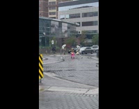 Three women dramatic pose middle street rain