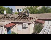 Construction workers take roof shingles apart dumpster