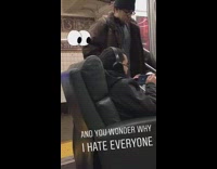 Guy sits on sofa couch and watches movie with headphones on subway train