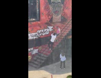 Guy pink tank top pose on stairs