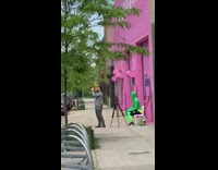 Guy in Green Tight Suit Sits on Chair 