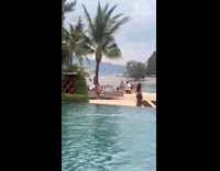 Woman brown bikini poses for resort video