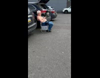 Collab winy - Shirtless old man sit beside car parking lot