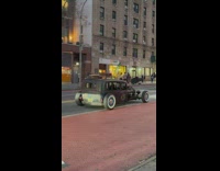 old metal car low to the ground drives away