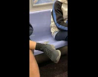 Guy pulls out weed from his pocket on subway train 