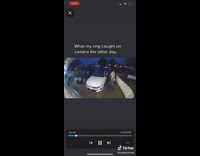 Couple kisses in the rain seen through Ring 