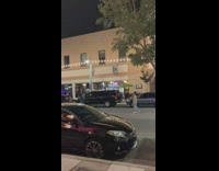 Guy cap brown sweater stand middle street