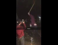 guy trying to pick up friend and falls down