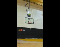 Guy spins basketball and shoots it backwards 