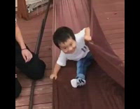 Little boy brown hammock swing flip fail wood floor