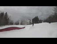Snowboarder rides on red curvy rail and faceplants into snow