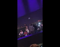 Two girls dance at the audience concert