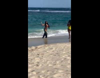 Woman in jeans walks by the beach