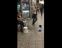 Subway drummers man white tank top wife beater dancing