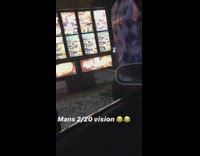 Guy gets out of car at drive taco bell drive thru to see the menu and order