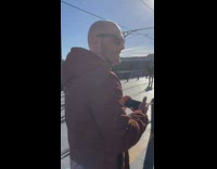 Two girls teal shirt dance on train tracks