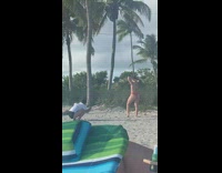 Woman red bikini tip toe pose beach