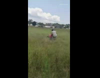 Guy falls off atv drives off field