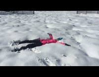 Girl pink jacket fall backwards on snow