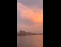 Sunset sky bridge and buildings East river
