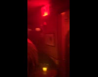 Woman black dress red light party photoshoot