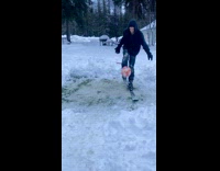 Guy bounce juggle ball with skis snow