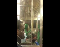 Two guys wearing green bodysuits dance subway 