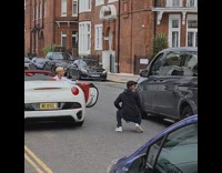 Photographer kneel avoid car street white car