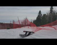 Guy snowboards over orange safety net and gets caught, trips and falls