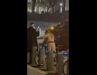 Woman brown jacket barefoot use rental bike