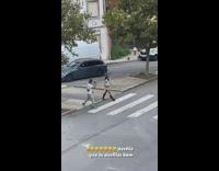Woman white sweater with boots walks on pedestrian lane