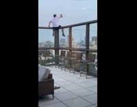 White shirt guy balcony wall railing selfie 