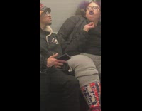 Woman has mouse crawling on her shoulder on subway train