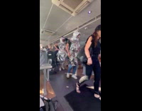 Couple wearing outfit made from emergency thermal blanket 