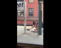 Woman sit on train station floor multiple phones
