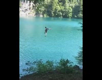 Rope swing backflip fail guy lands on back in blue water