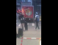 Two guys wearing eight ball jackets crosswalk