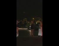 Group of people pose in the middle of the street