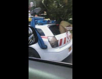 Driving by white ghost buster car on highway