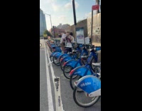 Two guys fight over citibike at rack
