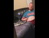Guy blue shirt show tummy couch home
